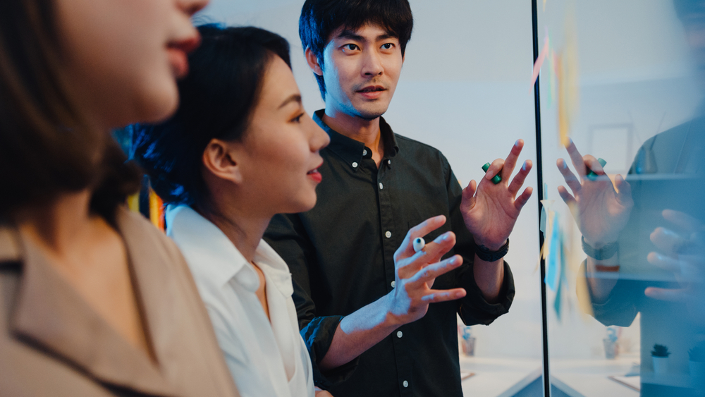 Asia,Businesspeople,Stand,Behind,Transparent,Glass,Wall,Listen,Manager,Pointing